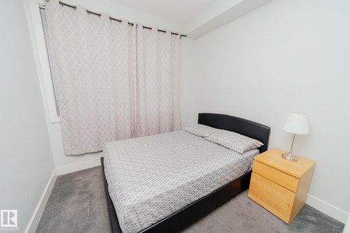 Carpeted bedroom featuring baseboards - 70 446 Allard Boulevard, Edmonton, AB - Indoor Photo Showing Bedroom
