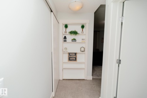 Hall with a textured ceiling - 70 446 Allard Boulevard, Edmonton, AB - Indoor Photo Showing Other Room