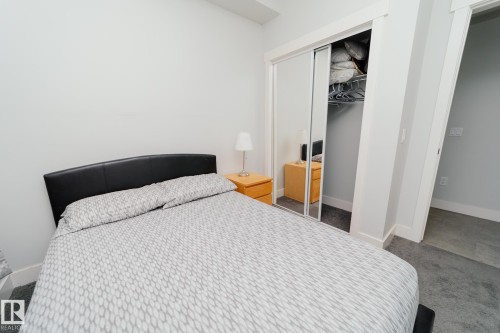 Carpeted bedroom featuring baseboards and a closet - 70 446 Allard Boulevard, Edmonton, AB - Indoor Photo Showing Bedroom