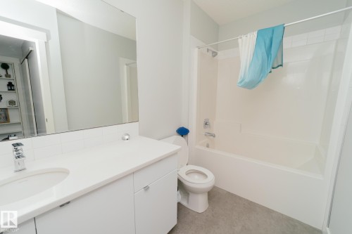 Bathroom with vanity and bathtub / shower combination - 70 446 Allard Boulevard, Edmonton, AB - Indoor Photo Showing Bathroom