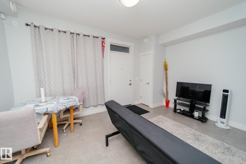 Living room featuring baseboards - 70 446 Allard Boulevard, Edmonton, AB - Indoor