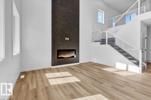 1119 Gyrfalcon Crescent, Edmonton, AB - Indoor Photo Showing Other Room With Fireplace