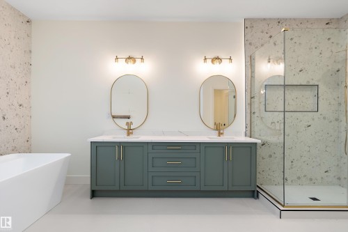 Bathroom featuring double vanity, a marble finish shower, a soaking tub, and light tile patterned flooring - Edmonton, AB - Indoor Photo Showing Bathroom