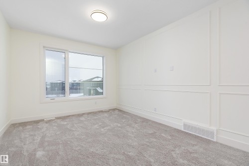 Carpeted spare room featuring a decorative wall - Edmonton, AB - Indoor Photo Showing Other Room