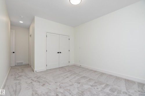 Unfurnished bedroom featuring light colored carpet, a closet, and recessed lighting - Edmonton, AB - Indoor Photo Showing Other Room