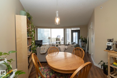 Dining space featuring dark wood-style floors and a textured ceiling - 1004 10136 104 Street, Edmonton, AB - Indoor Photo Showing Dining Room