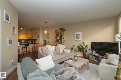 Living room featuring wood finished floors and a textured ceiling - 1004 10136 104 Street, Edmonton, AB - Indoor Photo Showing Living Room