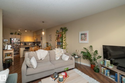 Living room with dark wood finished floors and rail lighting - 1004 10136 104 Street, Edmonton, AB - Indoor Photo Showing Living Room