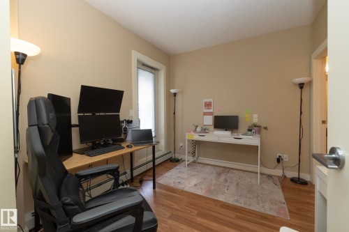 Office featuring light wood-style flooring and a baseboard radiator - 1004 10136 104 Street, Edmonton, AB - Indoor Photo Showing Office