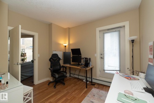 Office area with light wood-style flooring and baseboard heating - 1004 10136 104 Street, Edmonton, AB - Indoor