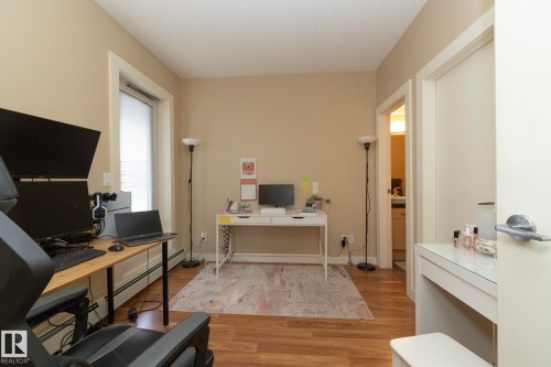 Office space with light wood-style floors and baseboard heating - 1004 10136 104 Street, Edmonton, AB - Indoor