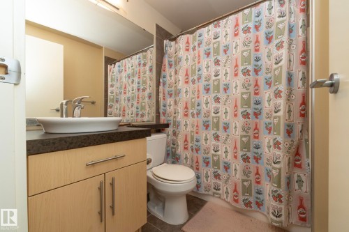 Full bath featuring vanity, a shower with curtain, and tile patterned flooring - 1004 10136 104 Street, Edmonton, AB - Indoor Photo Showing Bathroom