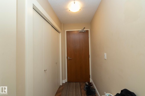 Doorway featuring a textured ceiling and wood finished floors - 1004 10136 104 Street, Edmonton, AB - Indoor Photo Showing Other Room