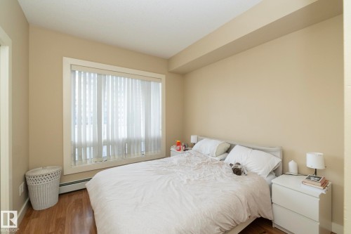 Bedroom featuring wood finished floors and a baseboard radiator - 1004 10136 104 Street, Edmonton, AB - Indoor Photo Showing Bedroom