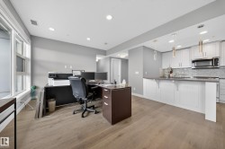 Home office with light wood-type flooring and recessed lighting - 