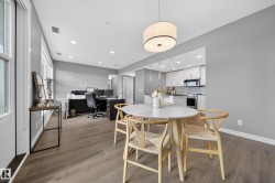 Dining room with an office area, light wood-style floors, and recessed lighting - 