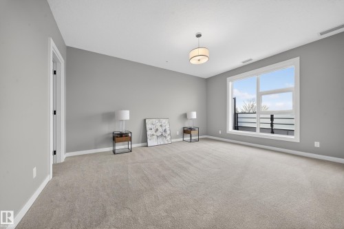 Unfurnished room with baseboards and light carpet - 416 61 Festival Way, Sherwood Park, AB - Indoor Photo Showing Other Room