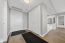 Foyer entrance with light wood-style flooring and a textured ceiling - 416 61 Festival Way, Sherwood Park, AB  - Indoor Photo Showing Other Room 