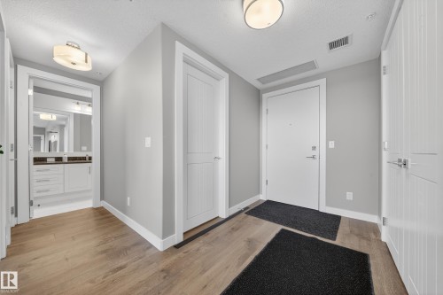 Entryway featuring light wood-style floors and a textured ceiling - 416 61 Festival Way, Sherwood Park, AB - Indoor Photo Showing Other Room