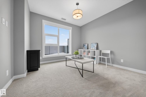 Sitting room with light colored carpet and baseboards - 416 61 Festival Way, Sherwood Park, AB - Indoor