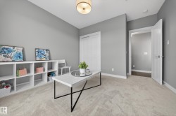Office space featuring light colored carpet and baseboards - 