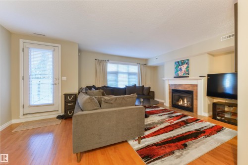 3 9026 Jasper Ave Avenue, Edmonton, AB - Indoor Photo Showing Living Room With Fireplace