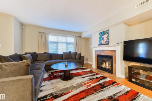 3 9026 Jasper Ave Avenue, Edmonton, AB - Indoor Photo Showing Living Room With Fireplace