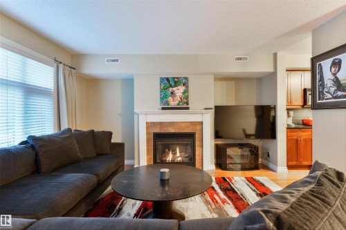 3 9026 Jasper Ave Avenue, Edmonton, AB - Indoor Photo Showing Living Room With Fireplace