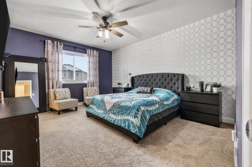 Bedroom with wallpapered walls, carpet, a textured ceiling, and a ceiling fan - 14 Spring Bay, Spruce Grove, AB - Indoor Photo Showing Bedroom