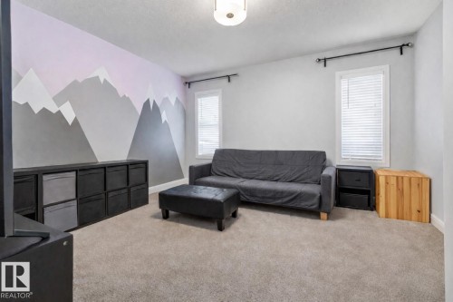 Living room featuring carpet and a textured ceiling - 14 Spring Bay, Spruce Grove, AB - Indoor