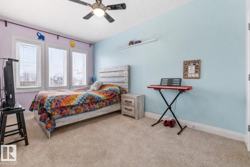 Carpeted bedroom with ceiling fan and baseboards - 14 Spring Bay, Spruce Grove, AB - Indoor Photo Showing Bedroom