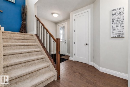 Stairway with baseboards and hardwood / wood-style flooring - 14 Spring Bay, Spruce Grove, AB - Indoor Photo Showing Other Room