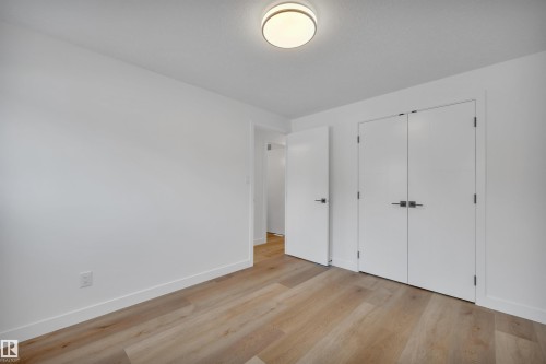 Unfurnished bedroom featuring light wood-type flooring and a closet - 5021 46 Avenue, Calmar, AB - Indoor Photo Showing Other Room