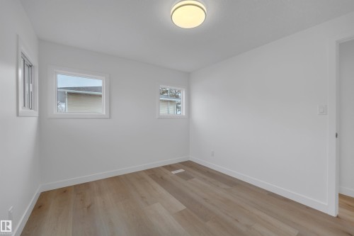 Empty room featuring light wood finished floors and baseboards - 5021 46 Avenue, Calmar, AB - Indoor Photo Showing Other Room