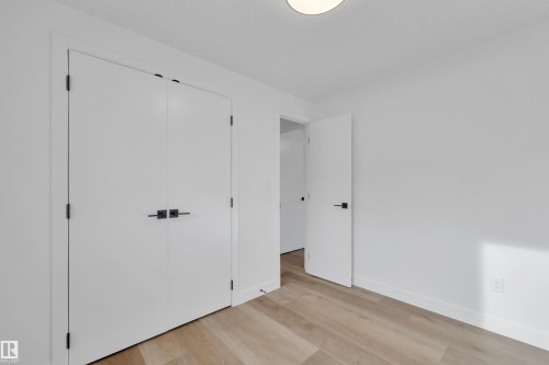 Unfurnished bedroom featuring light wood-style flooring and a closet - 5021 46 Avenue, Calmar, AB - Indoor Photo Showing Other Room