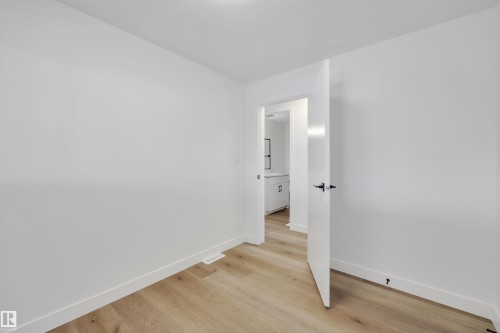 Spare room with baseboards and light wood finished floors - 5021 46 Avenue, Calmar, AB - Indoor Photo Showing Other Room