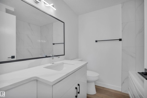 Bathroom with vanity and light wood-style floors - 5021 46 Avenue, Calmar, AB - Indoor Photo Showing Bathroom