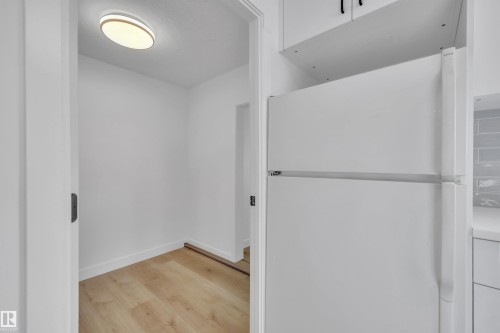 Bathroom with light wood-type flooring and baseboards - 5021 46 Avenue, Calmar, AB - Indoor Photo Showing Other Room