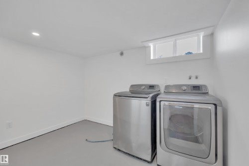 Laundry area featuring finished concrete floors, washer and clothes dryer, and recessed lighting - 5021 46 Avenue, Calmar, AB - Indoor Photo Showing Laundry Room