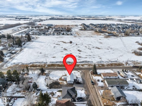 Snowy aerial view with a residential view - 5021 46 Avenue, Calmar, AB - Outdoor With View