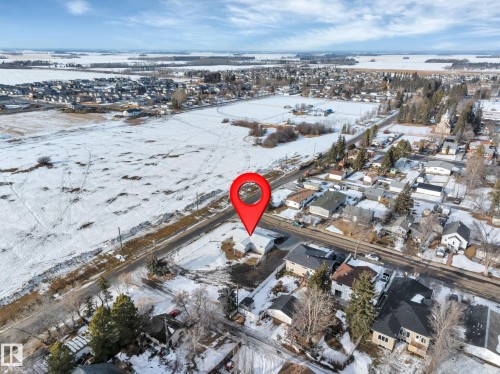 Snowy aerial view with a residential view - 5021 46 Avenue, Calmar, AB - Outdoor With View