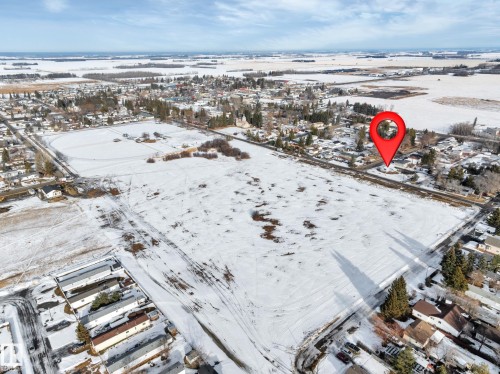 Snowy aerial view with a residential view - 5021 46 Avenue, Calmar, AB - Outdoor With View