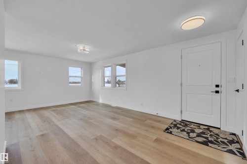 Foyer entrance featuring light wood-style flooring and baseboards - 5021 46 Avenue, Calmar, AB - Indoor Photo Showing Other Room