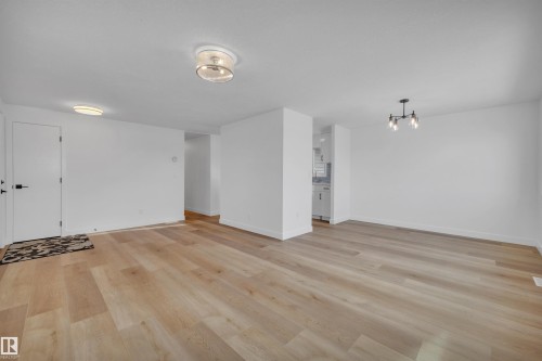 Unfurnished room with light wood-style floors and hanging lights - 5021 46 Avenue, Calmar, AB - Indoor Photo Showing Other Room