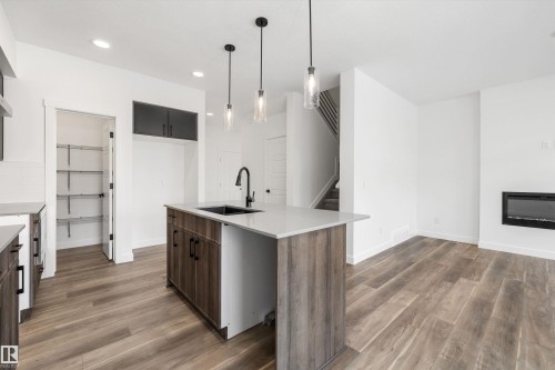 1166 South Creek Wynd, Stony Plain, AB - Indoor Photo Showing Kitchen With Fireplace With Upgraded Kitchen