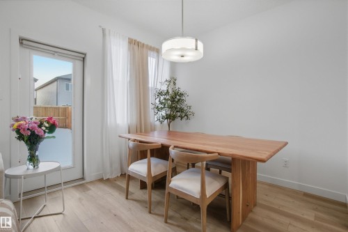 Dining area with light wood-style floors and baseboards - 9882 225A St Nw, Edmonton, AB - Indoor Photo Showing Dining Room