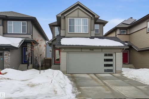 View of front of home with a garage, entry steps, driveway, and a shingled roof - 9882 225A St Nw, Edmonton, AB - Outdoor With Facade