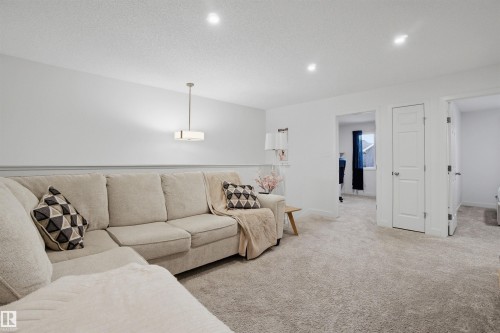 Carpeted living area with recessed lighting and a textured ceiling - 9882 225A St Nw, Edmonton, AB - Indoor Photo Showing Living Room