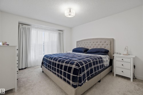 Bedroom with light colored carpet and a textured ceiling - 9882 225A St Nw, Edmonton, AB - Indoor Photo Showing Bedroom