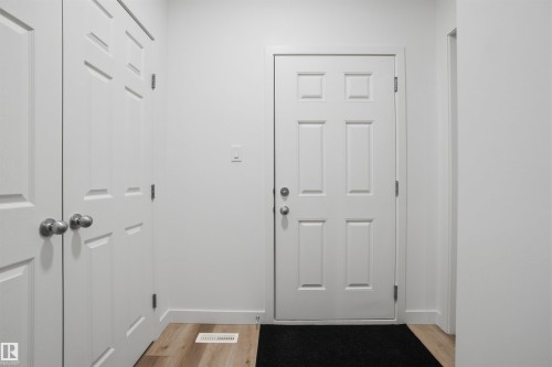 Doorway with wood finished floors and baseboards - 9882 225A St Nw, Edmonton, AB - Indoor Photo Showing Other Room
